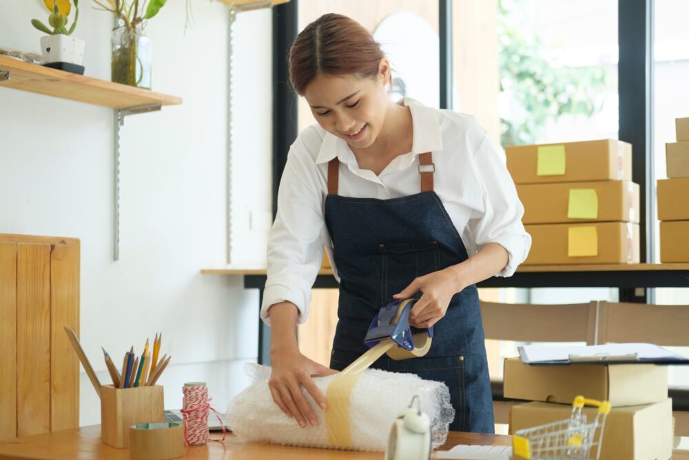 female-online-business-owner-packing-order-box-for-dispatching--e1763725812716.jpg